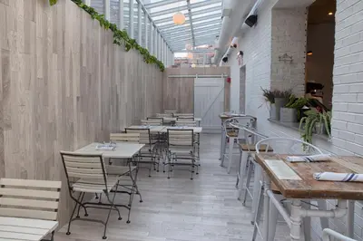 a row of tables and chairs in a restaurant at Holiday Inn Brooklyn Downtown by IHG in Brooklyn