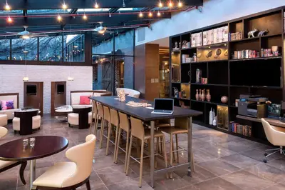 a restaurant with a table and chairs and a book shelf at Holiday Inn Brooklyn Downtown by IHG in Brooklyn