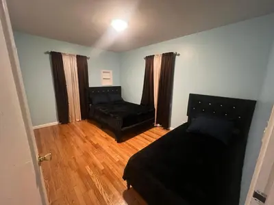 a living room with a bed and a couch at La Casa Bonita Near NYC in Yonkers