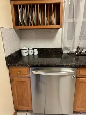 a kitchen counter with a sink and a dishwasher at La Casa Bonita Near NYC in Yonkers