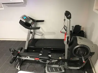 a gym room with a treadmill and a machine at La Casa Bonita Near NYC in Yonkers