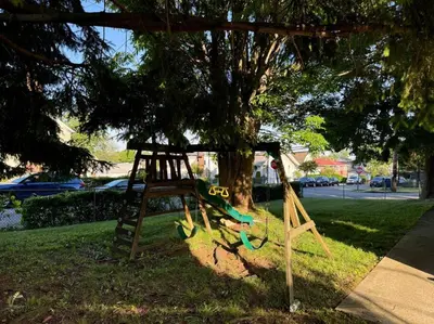 a swing set in front of a tree at La Casa Bonita Near NYC in Yonkers