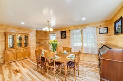 a dining room with a table and chairs at Creekside Cabin in Bainbridge with Wraparound Deck! in Sidney