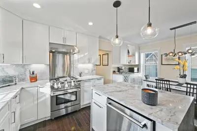 a kitchen with white cabinets and a stove top oven at Upscale Azure by Saratoga Stays in Saratoga Springs