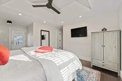 a bedroom with two white beds and a flat screen tv at Upscale Azure by Saratoga Stays in Saratoga Springs