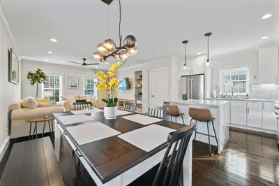 a dining room and living room with a table and a kitchen at Upscale Azure by Saratoga Stays in Saratoga Springs