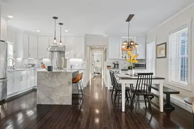 a kitchen with a table and chairs and a dining room at Upscale Azure by Saratoga Stays in Saratoga Springs