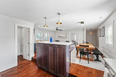 an open kitchen and dining room with a table at Azure Loft by Saratoga Stays in Saratoga Springs