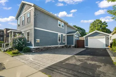a large blue house with a driveway at Azure Loft by Saratoga Stays in Saratoga Springs