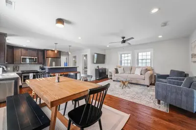a kitchen and living room with a table and chairs at Azure Loft by Saratoga Stays in Saratoga Springs