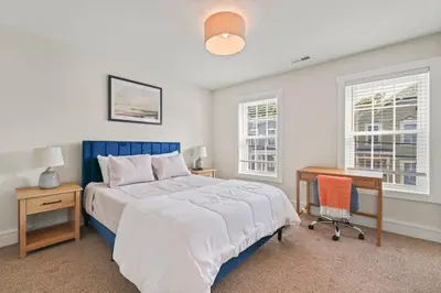 a bedroom with a bed and a desk and a chair at Azure Loft by Saratoga Stays in Saratoga Springs