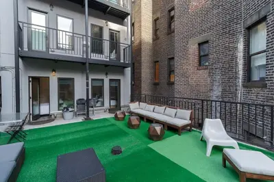 a patio with green grass in front of a building at Park South Central 3 Bedroom with Private Terrace in New York