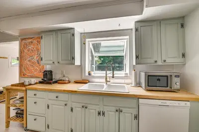 a kitchen with a sink and a microwave at Charming Catskills Getaway Hike, Bike, Sip and More in Acra