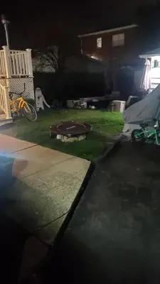 a backyard at night with a skateboard on the grass at The Fred Deluxe 7 BR by I95 Train HarborVw Beach in Stamford
