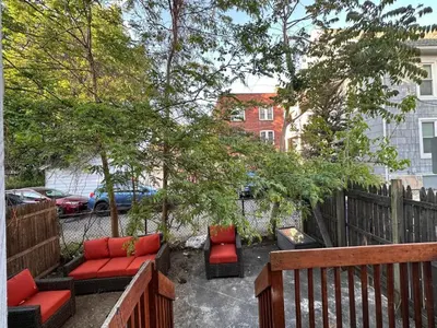 a patio with couches and chairs in a backyard at Modern 3 Bed House in Black Rock in Bridgeport