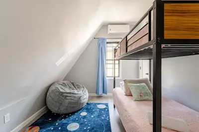 a small bedroom with a bunk bed and a rug at Modern 3 Bed House in Black Rock in Bridgeport