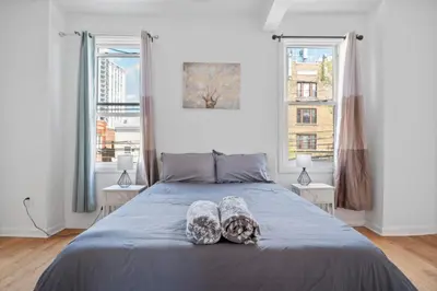 a bedroom with a bed with two pillows on it at Modern Home 4BR 3BA - 20 Min to Timesquare in Jersey City
