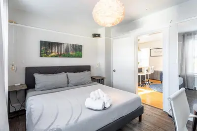 a bedroom with a bed and a chandelier at Spacious&Gracious- 5BR Fam-Friendly near I95&Shops in Fairfield