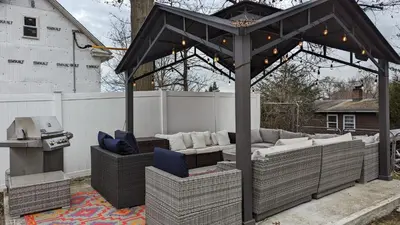a pergola with couches and a grill in a backyard at Spacious&Gracious- 5BR Fam-Friendly near I95&Shops in Fairfield