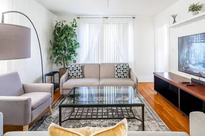 a living room with a couch and a coffee table at The B&W Haven 5BR Home with yard theater in Bridgeport