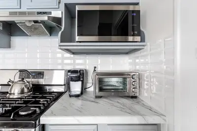 a kitchen with a toaster oven and a microwave at The B&W Haven 5BR Home with yard theater in Bridgeport