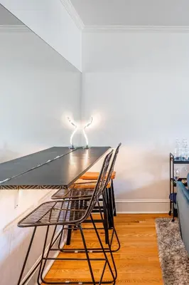 a dining room with a table and a chair at The B&W Haven 5BR Home with yard theater in Bridgeport
