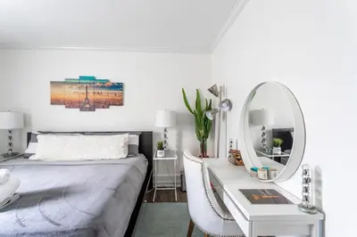 a bedroom with a bed and a mirror and a desk at Modern 3BR Apartment Downtown HarborPt I-95 Train in Stamford