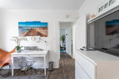 a living room with a white desk and a tv at Modern 3BR Apartment Downtown HarborPt I-95 Train in Stamford
