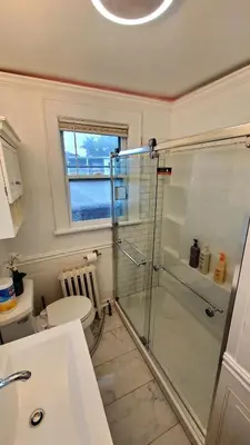 a bathroom with a shower and a toilet at Modern 3BR Apartment Downtown HarborPt I-95 Train in Stamford