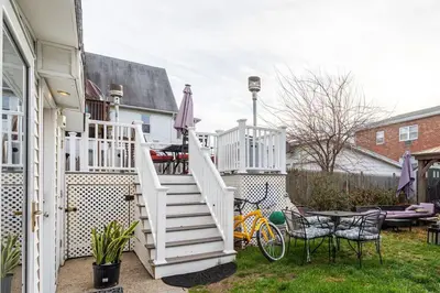 a staircase leading up to a house with a table and chairs at Modern 3BR Apartment Downtown HarborPt I-95 Train in Stamford