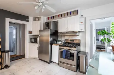 a kitchen with a stainless steel stove and refrigerator at Sunshine Room by harbor downtown beach I-95&Train in Stamford