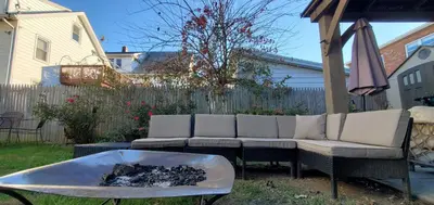 a backyard with a couch and a fire pit at Sunshine Room by harbor downtown beach I-95&Train in Stamford