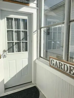 a white door with a sign in front of a garage at Sunshine Room by harbor downtown beach I-95&Train in Stamford
