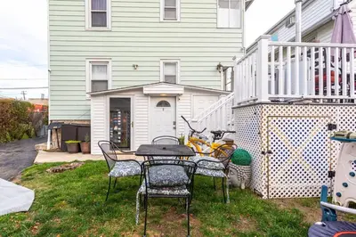 a table and chairs in front of a house at Bella room near downtown Train I-95 & beaches in Stamford