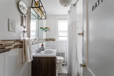 a bathroom with a sink and a toilet and a mirror at Bella room near downtown Train I-95 & beaches in Stamford