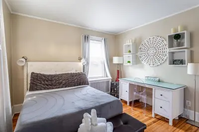 a bedroom with a bed and a desk at Bella room near downtown Train I-95 & beaches in Stamford