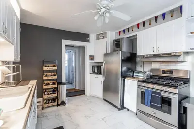 a kitchen with a stainless steel stove and refrigerator at Bella room near downtown Train I-95 & beaches in Stamford