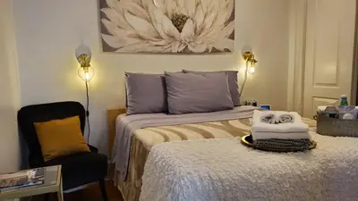 a bedroom with a bed and a chair with a mask on it at The Gold Room near downtown trains fast wifi in Stamford