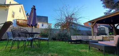 a patio with a table and chairs and an umbrella at The Gold Room near downtown trains fast wifi in Stamford