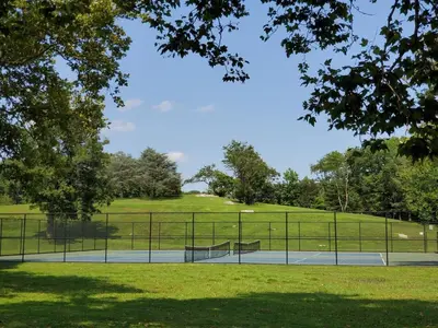 a park with a bench in the middle of a field at The Gold Room near downtown trains fast wifi in Stamford