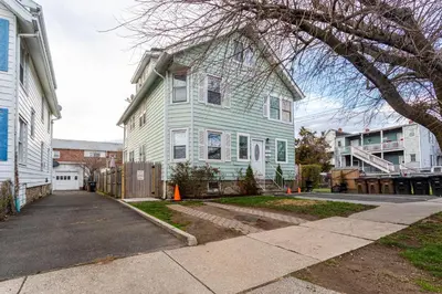 a house with a blue house at Stamford Bohemian by HarborPoint Downtown &Train in Stamford