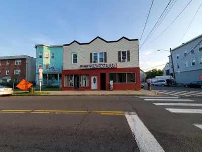 a building on the corner of a street at Stamford Bohemian by HarborPoint Downtown &Train in Stamford