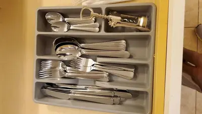a drawer full of silver utensils in a cabinet at The Blue Sapphire 2BR 2 King beds & ample backyard in Bridgeport