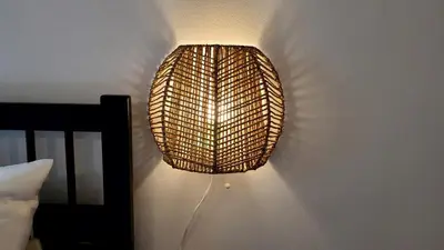 a lamp hanging on a wall next to a bed at The Blue Sapphire 2BR 2 King beds & ample backyard in Bridgeport