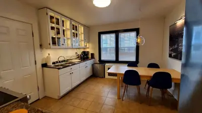 a kitchen with a table and chairs in a kitchen at The Blue Sapphire 2BR 2 King beds & ample backyard in Bridgeport