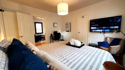 a bedroom with a bed with a tv on the wall at The Blue Sapphire 2BR 2 King beds & ample backyard in Bridgeport