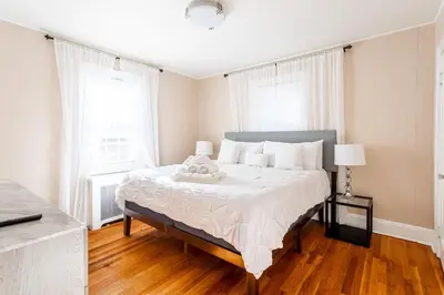 a bedroom with a bed with a teddy bear on it at The B&W Haven 3BR private office by LI Ferry in Bridgeport