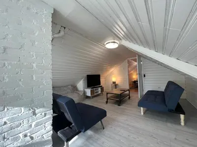 a living room with two chairs and a couch at The B&W Haven 3BR private office by LI Ferry in Bridgeport