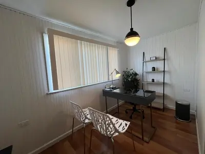 a room with a desk and chairs and a window at The B&W Haven 3BR private office by LI Ferry in Bridgeport