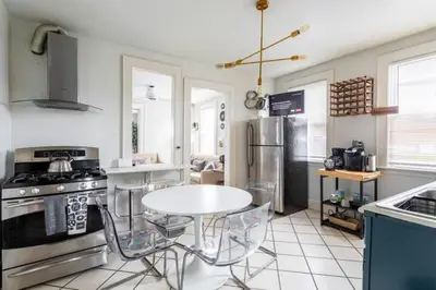a kitchen with a table and chairs in a kitchen at Revamped 3BR Apt with Easy Check-In Family-Friendly in Bridgeport